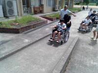 車いすに乗っている友だちを介助しています